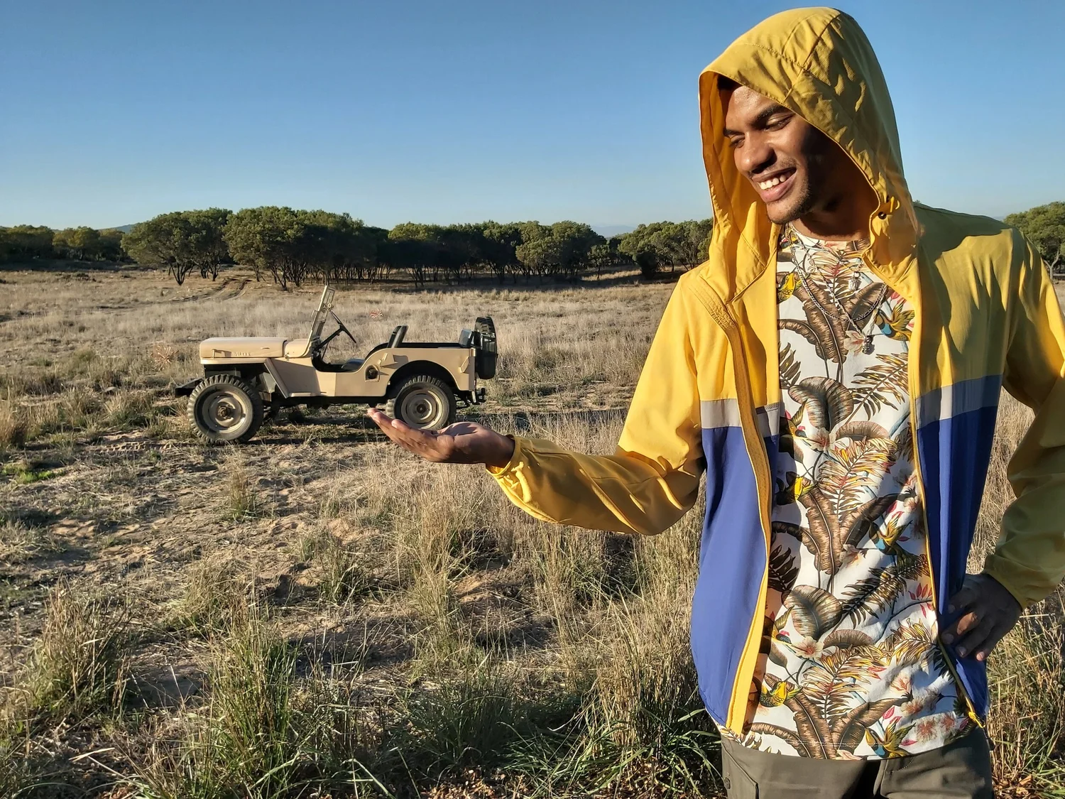 Model in a field with a jeep, shot at 80º wide angle